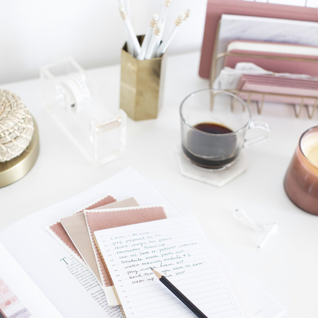 A desk with some papers and candles on it