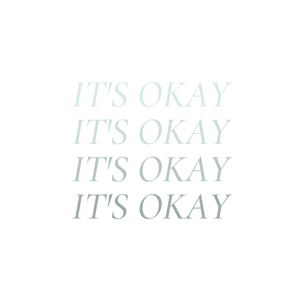 A white sticker with the words " it's okay " written in green.